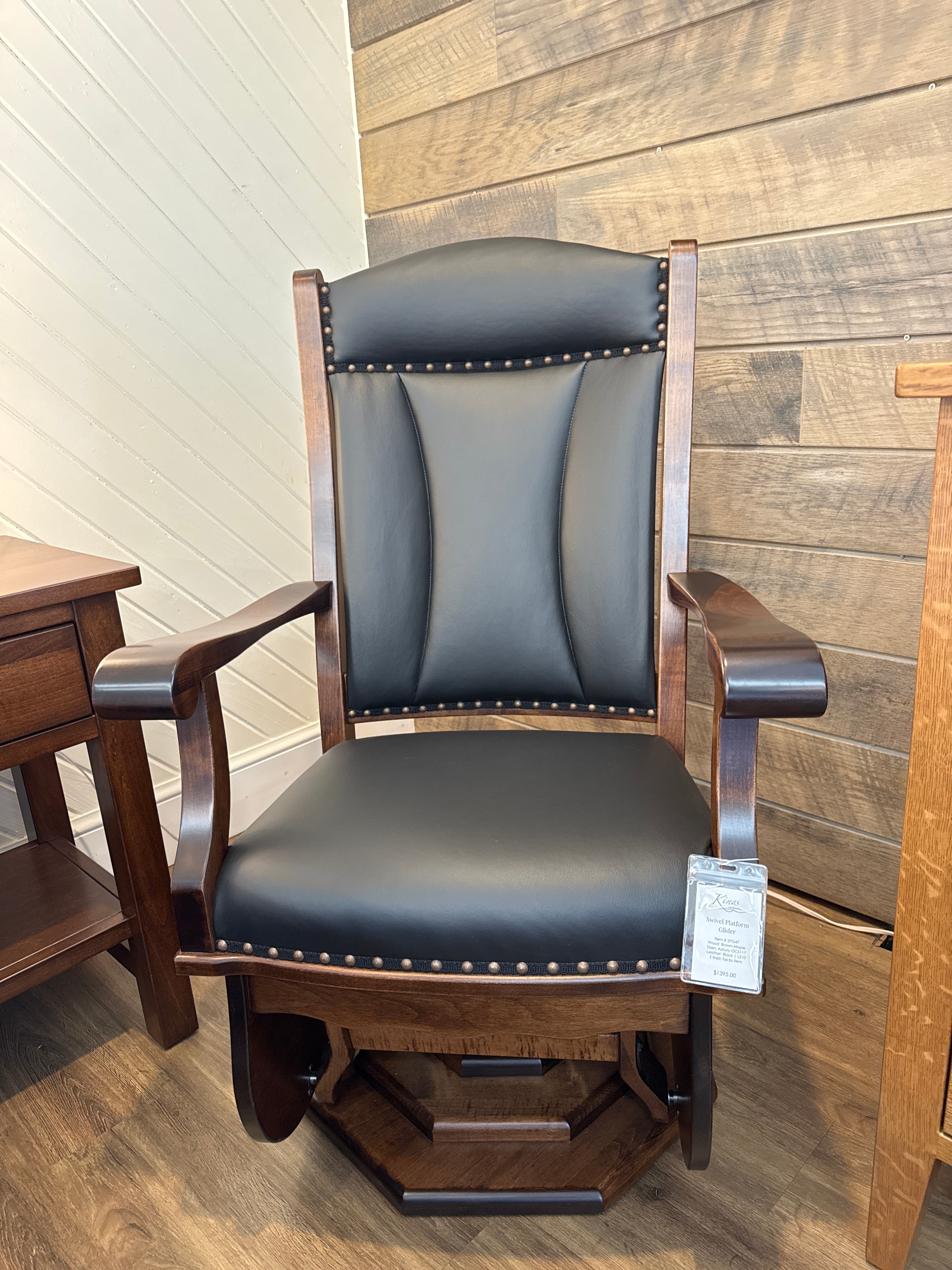 Front view of Amish made swivel glider rocker chair in solid maple hardwood with black leather upholstered cushions – handcrafted furniture