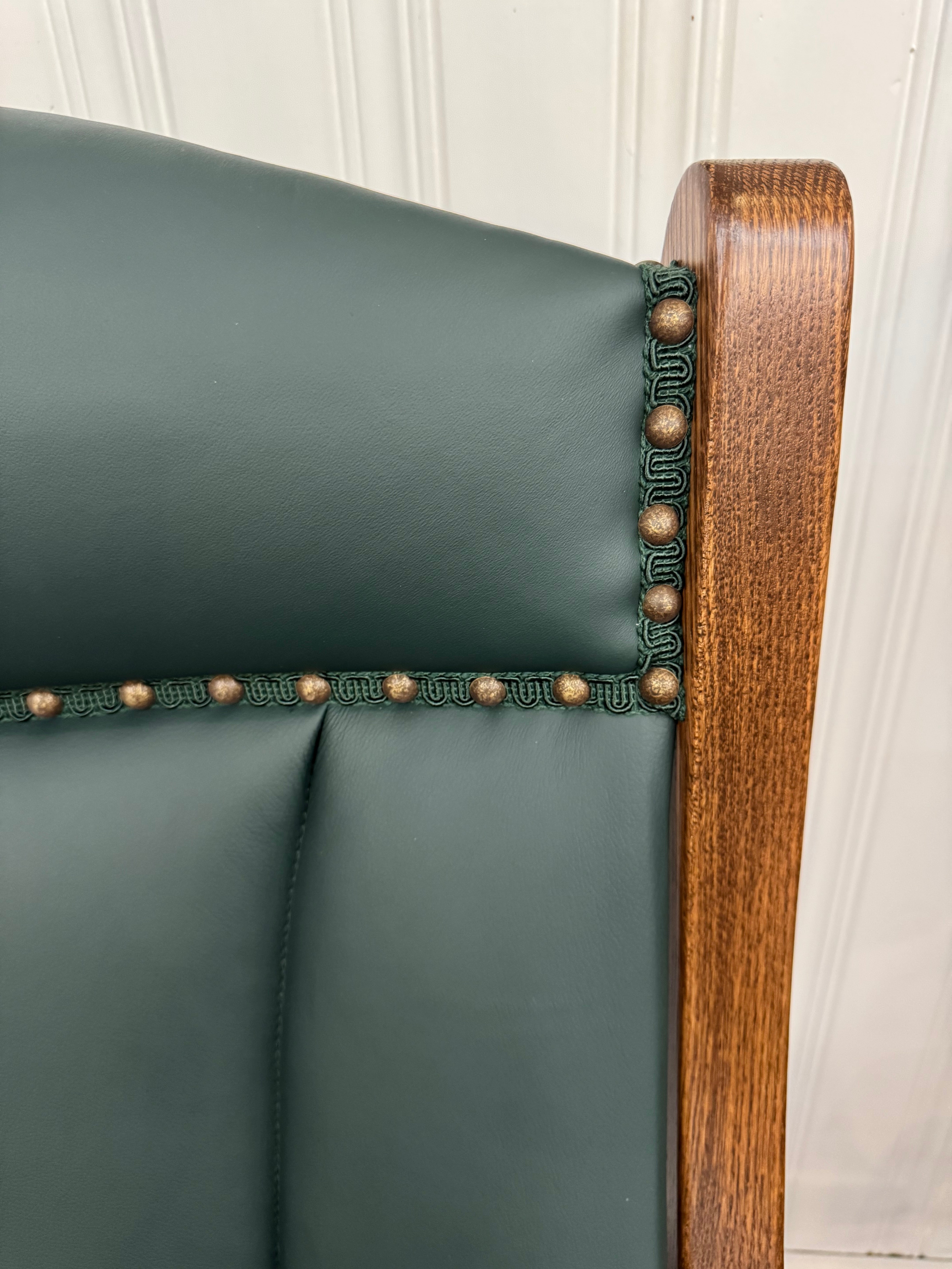 Close up view of Amish made swivel glider rocker chair in solid oak with hunter green upholstered cushions – handcrafted furniture